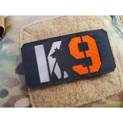 JTG K9 LaserCut Patch, schwarz, Cordura, reflektierendes Logo und Schriftzug, mit Klettrückseite